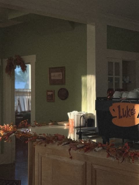 Morning light across the coffee bar decorated with fall garland