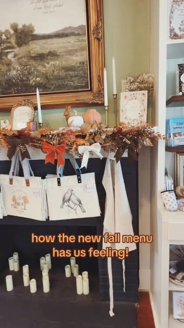 Mantel decorated for fall with Selah tote bags, aprons and candles