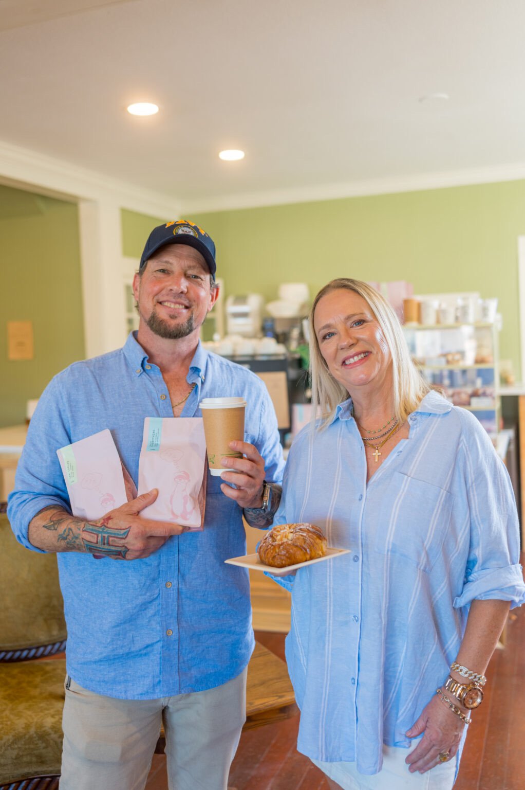 Stephen and D'Ann Gimenez smiling inside Selah with a coffee and a fresh pastry
